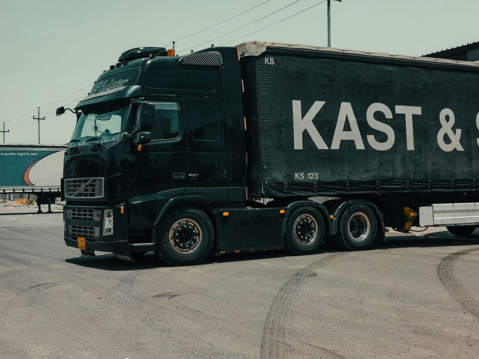 A large industrial truck parked on a city street in an urban setting.