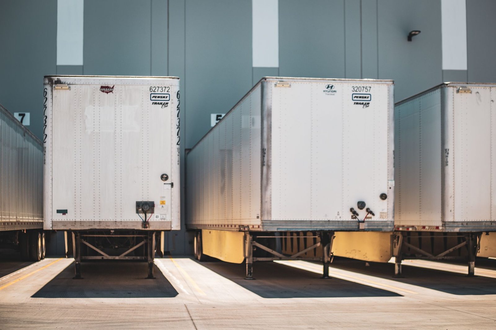 A row of freight trailers parked at a commercial loading dock.
