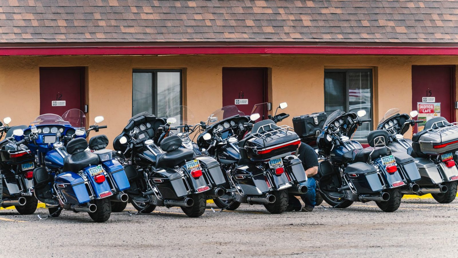 Several touring motorcycles parked in a row in front of a motel on Route 66 in Williams, Arizona.