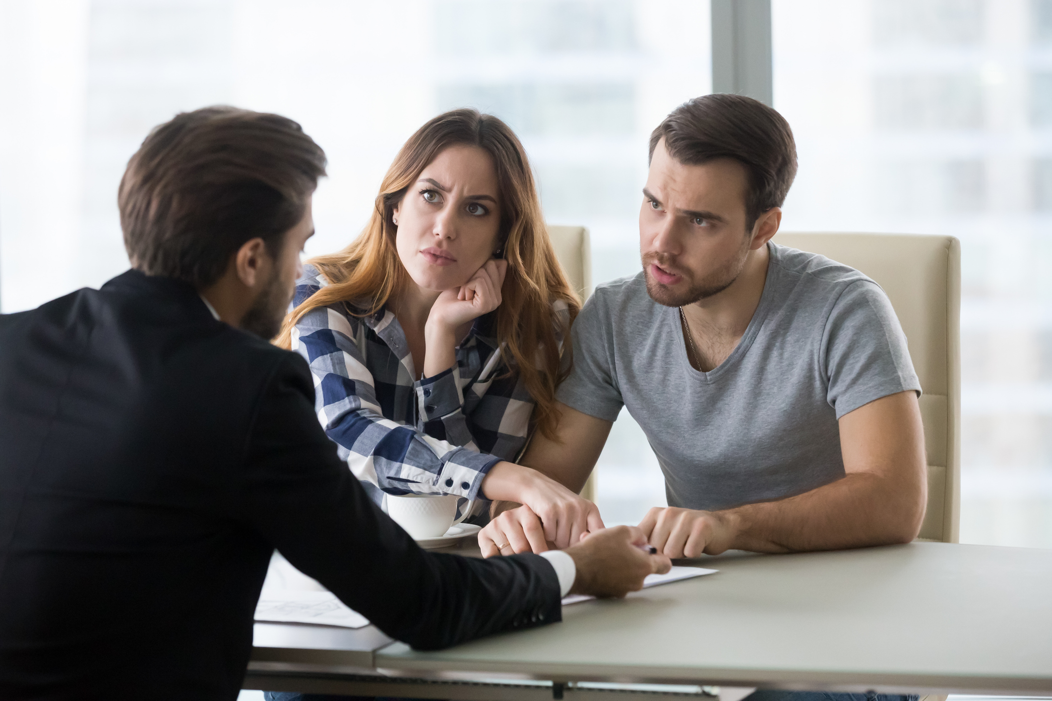 Angry couple arguing meeting insurance adjuster